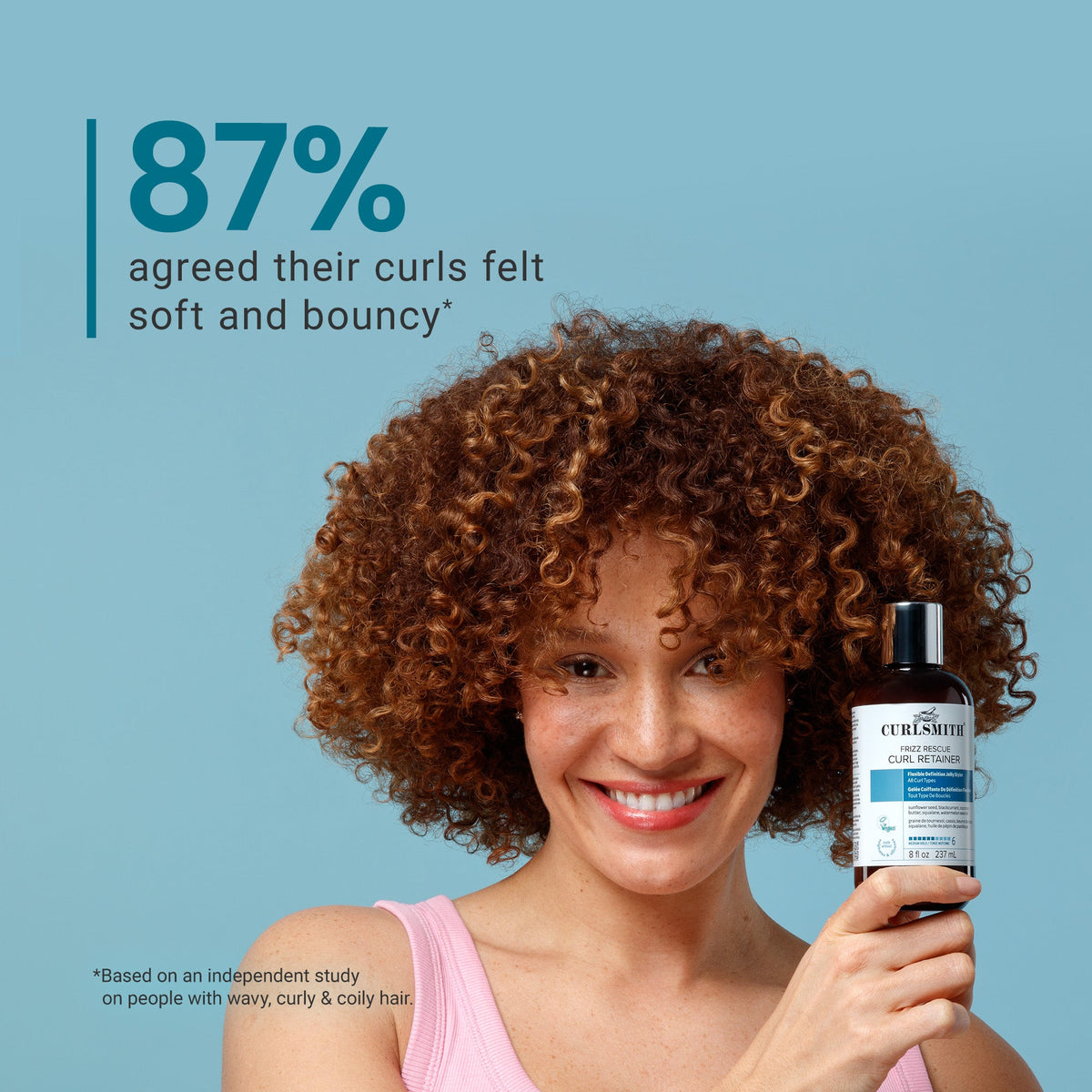 Woman holding a bottle of Curlsmith Frizz Rescue Curl Retainer with text about curl satisfaction on a blue background