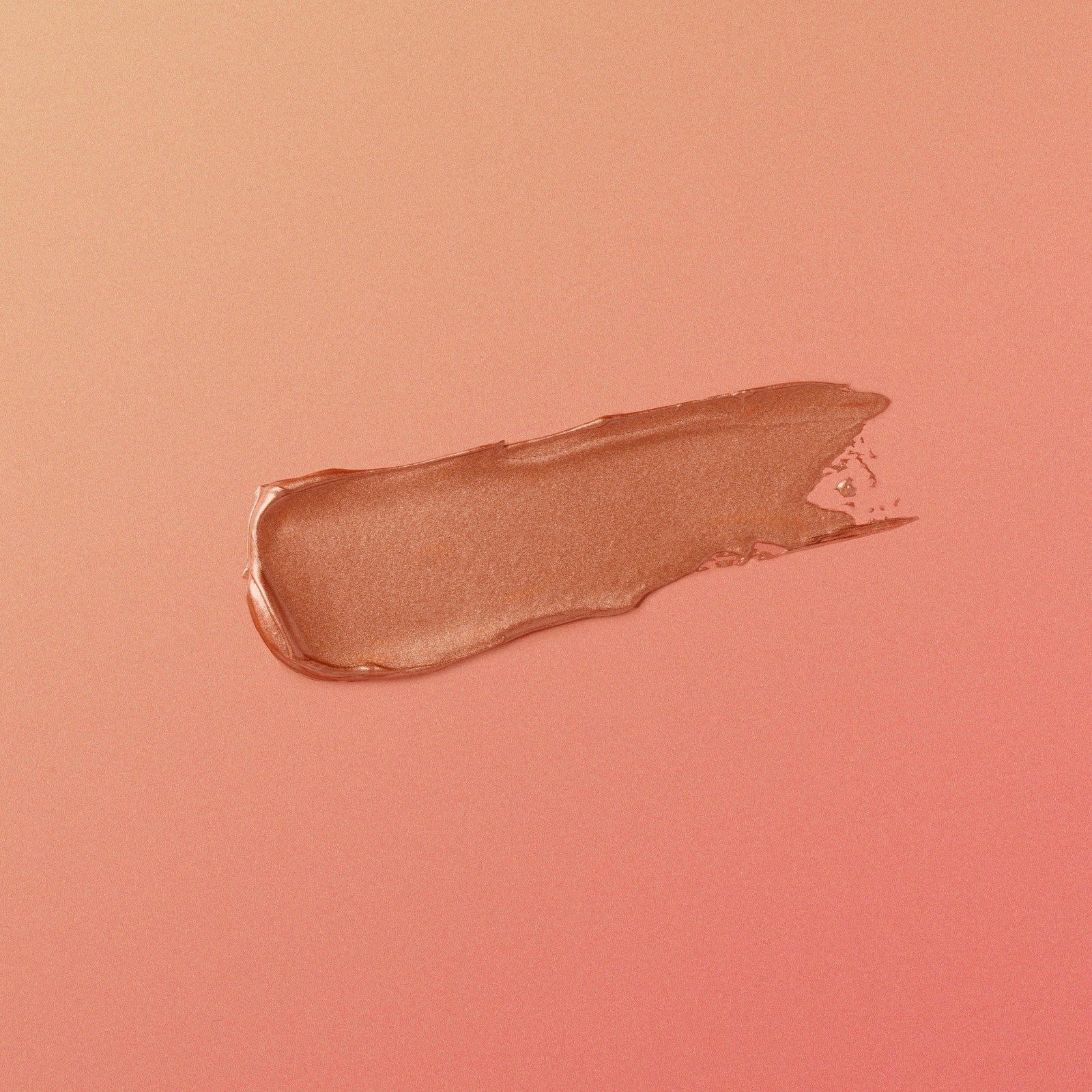 rose-gold-colored makeup swatch on a matching pink background