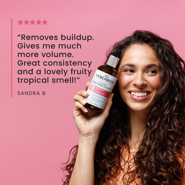 Woman holding a bottle of hair product with positive review text on a pink background