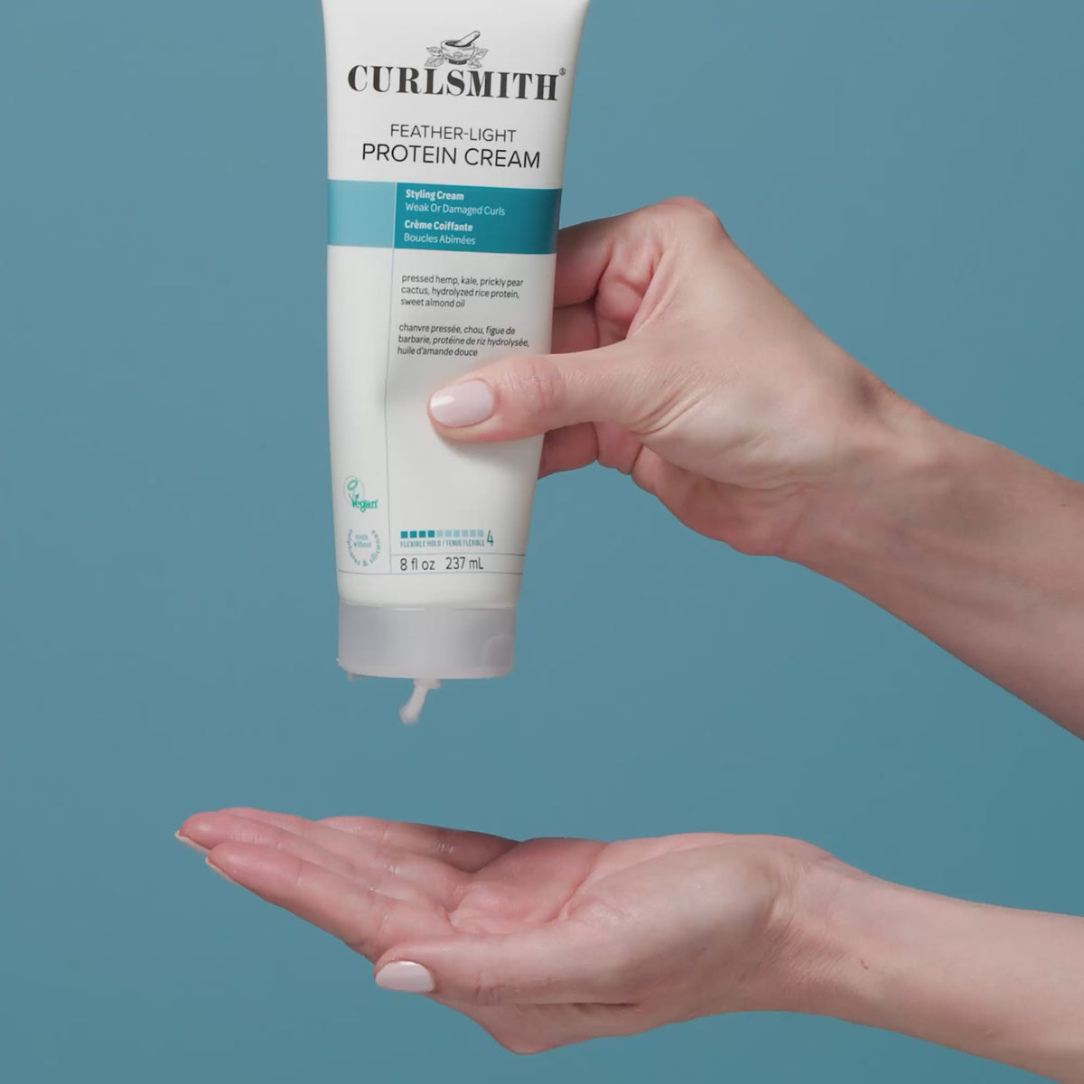 Hand squeezing feather-light protein cream into hand