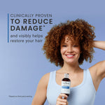 Woman holding a bottle of Bond curl rehab salve hair care product with text about reducing damage and restoring hair.