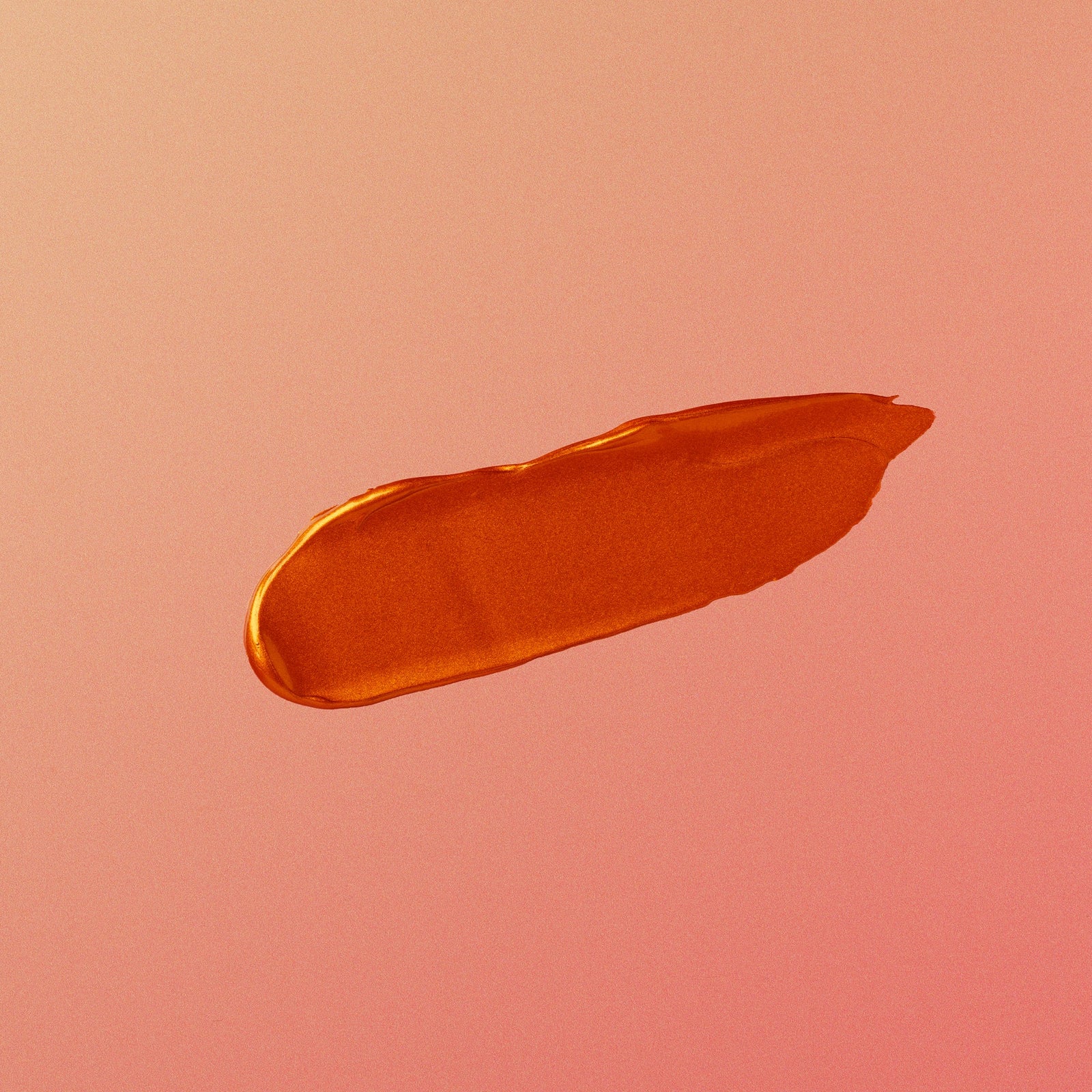 Copper makeup swatch on a pink background