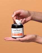 Person holding a jar of Curlsmith Curlsmith Curl Conditioning Oil-in-cream with a brown background