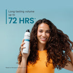Woman holding a bottle of Invincible Volume Mousse with text about long-lasting volume on a blue background