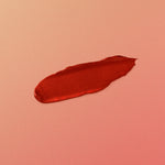 Red hair make-up swatch on a pink background