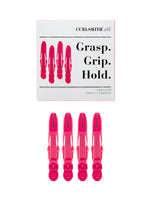 Set of pink hair clips with packaging displaying 'Curlsmith' and text on a white background