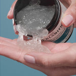 Hand dipping jar of Curl Defining souffle jelly into other hand