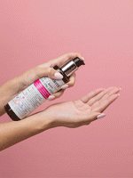 Hand squeezing out Full Body Volumizing lotion into hand