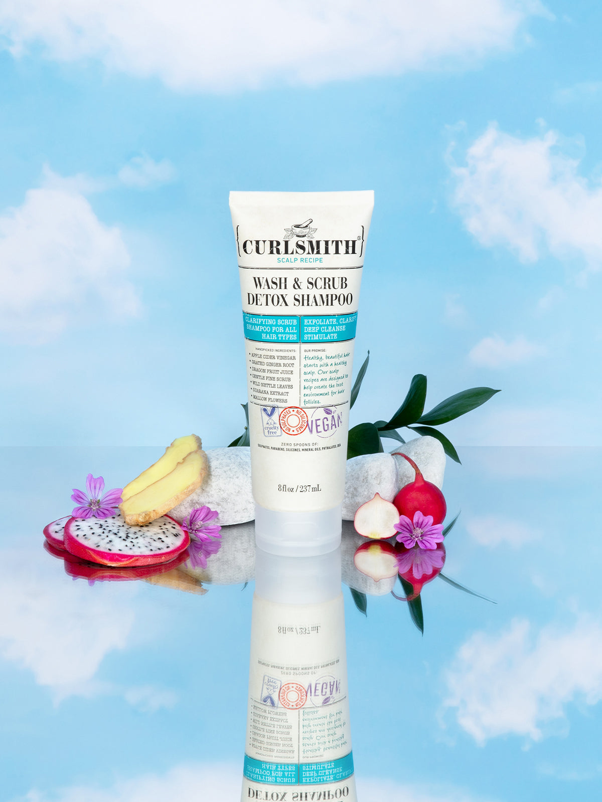Curlsmith shampoo tube with decorative elements on a blue sky background