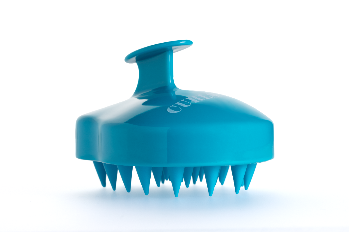 A blue scalp massager with the brand name Curlsmith inscribed on it.