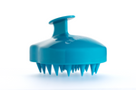 A blue scalp massager with the brand name Curlsmith inscribed on it.